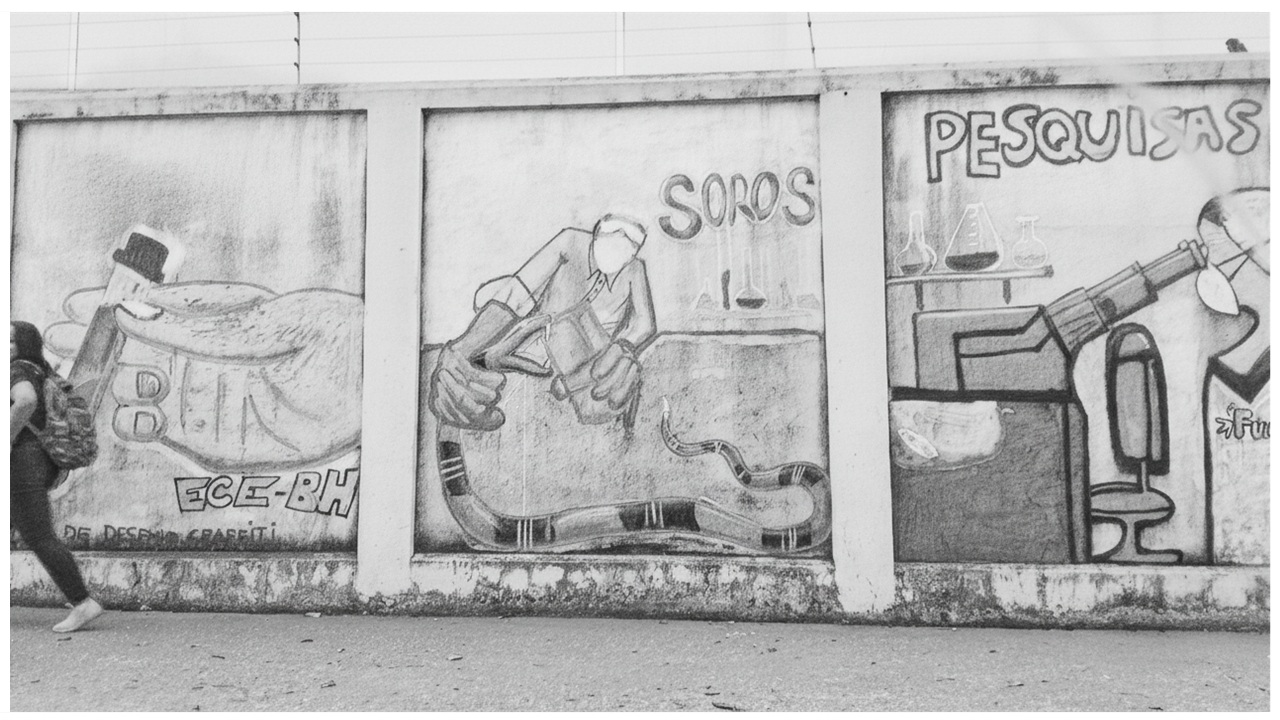 Reprodução em desenho de foto do muro da FUNED, em que aparecem, em grafite, as palavras pesquisa e soros, em contexto de laboratório de pesquisa. Trata-se de uma tentativa de mostrar, no muro, elementos do que ocorre dentro do prédio, oferecendo à sociedade um contexto das pesquisas.